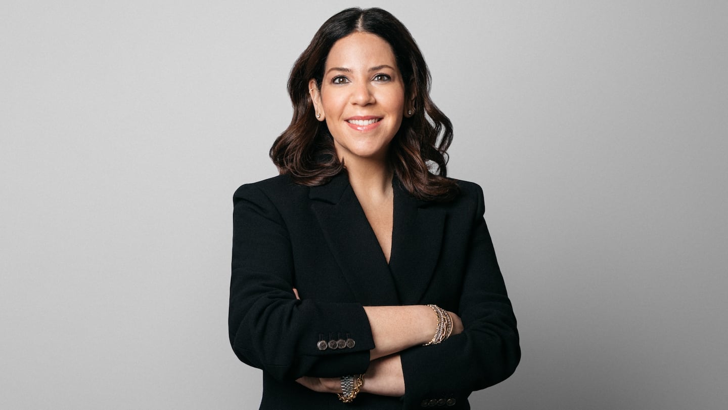 A woman posing with arms folded